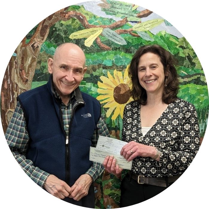 Donor giving check to Executive Director